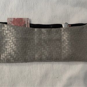 Wrist wallet. Black polyester and scalloped front with tan Faux leather fabric.